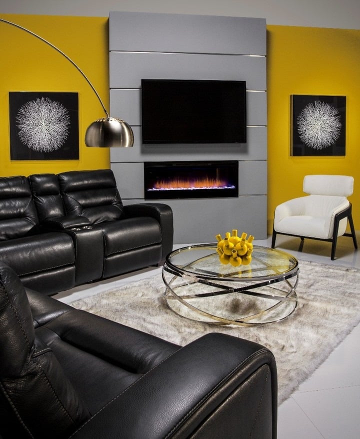 8. Black Recliner Sofa with Bold Yellow Wall - black sofa living room ideas