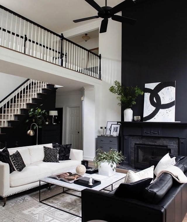 12. Black and White Living Room with Statement Wall - black sofa living room ideas