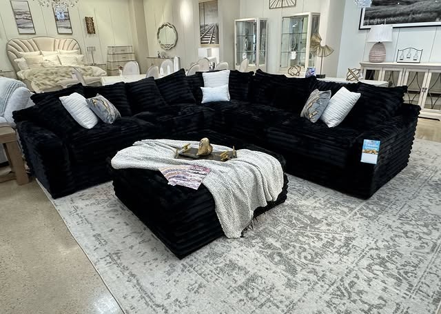 18. Plush Black Sectional with Soft Textiles - black sofa living room ideas