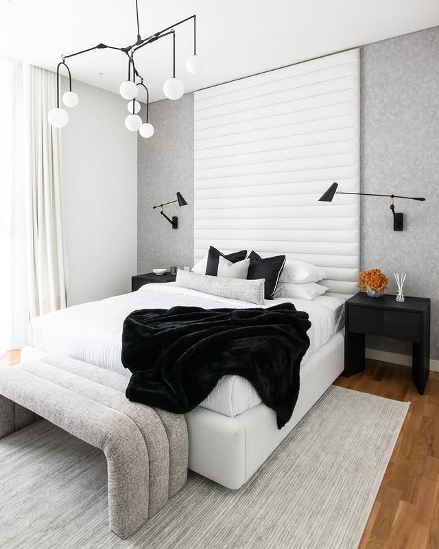 9. Modern Minimal Black and White Bedroom with Sculptural Lighting - black and white bedroom ideas