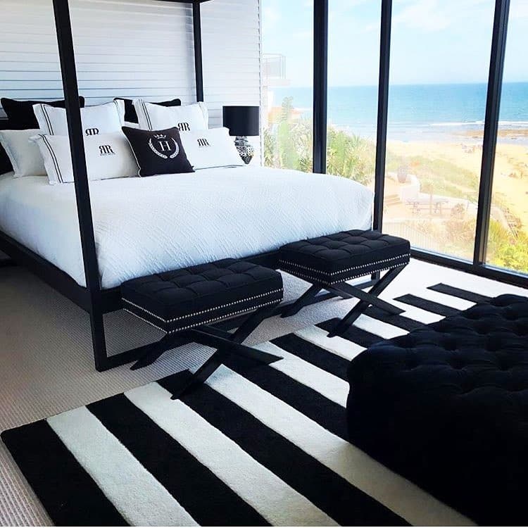 18. Coastal Black and White Bedroom with Panoramic Views - black and white bedroom ideas