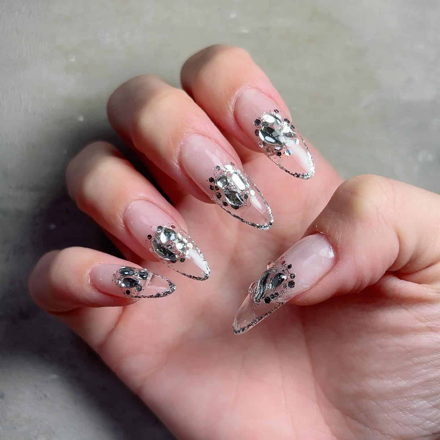 3. Crystal Edge Nude Stiletto Nails with Silver Accents - ice nail ideas