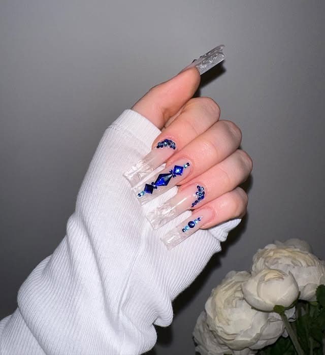 8. Clear Acrylic Coffin Nails with Blue Gem Accents - ice nail ideas