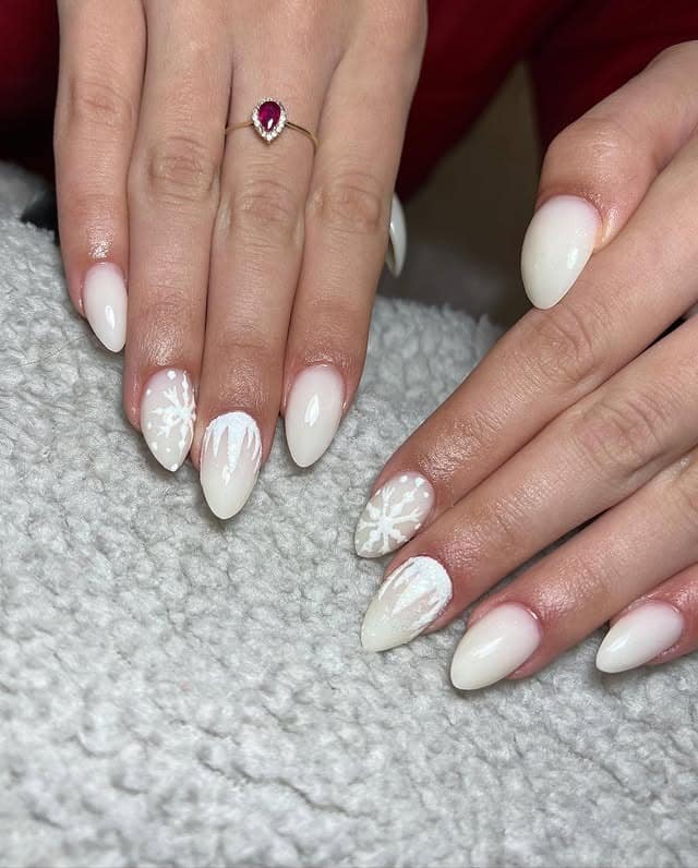 16. Snowy White Almond Nails with Hand-Painted Snowflake Art - ice nail ideas