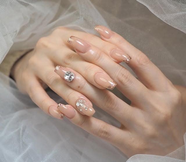 7. Nude Nails with Gold Foil and Crystal Detail - simple nail ideas