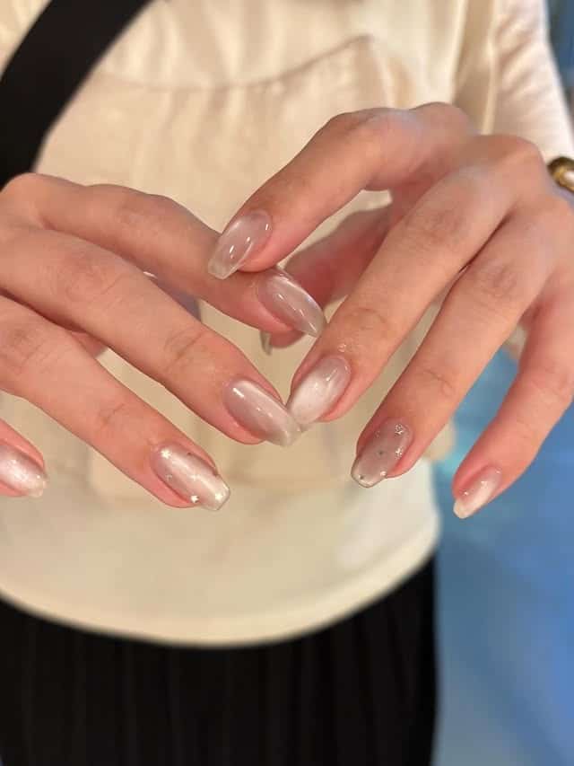 17. Sheer Nude Gradient Almond Nails with Star Accents - simple nail ideas
