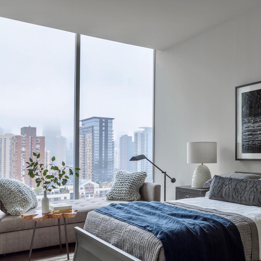 9. Light-Filled Gray Bedroom with Urban View - gray bedroom ideas