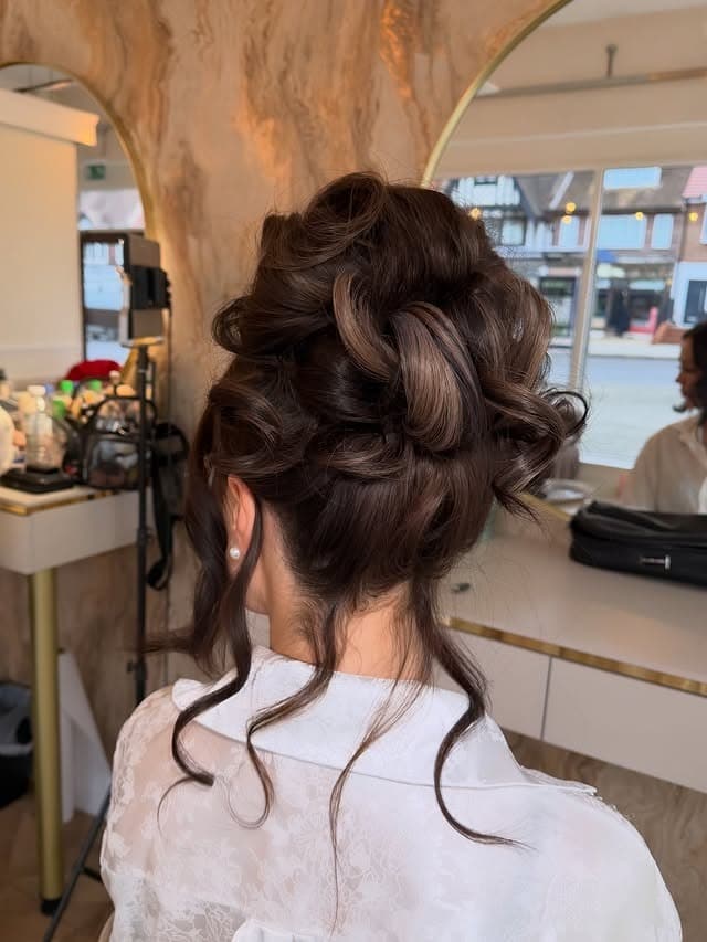 12. Rich Brunette Textured Low Bun - Medium Length Hair Messy Updos