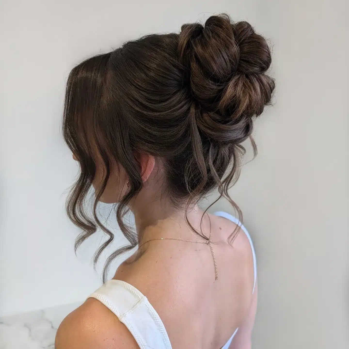 22. Medium Brunette Soft Textured High Bun - Medium Length Hair Messy Updos