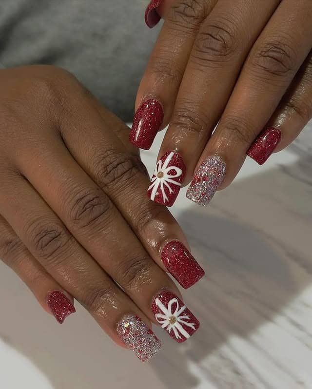 1. Classic Red Glitter with White Bow Accent Nails - christmas dip nail ideas
