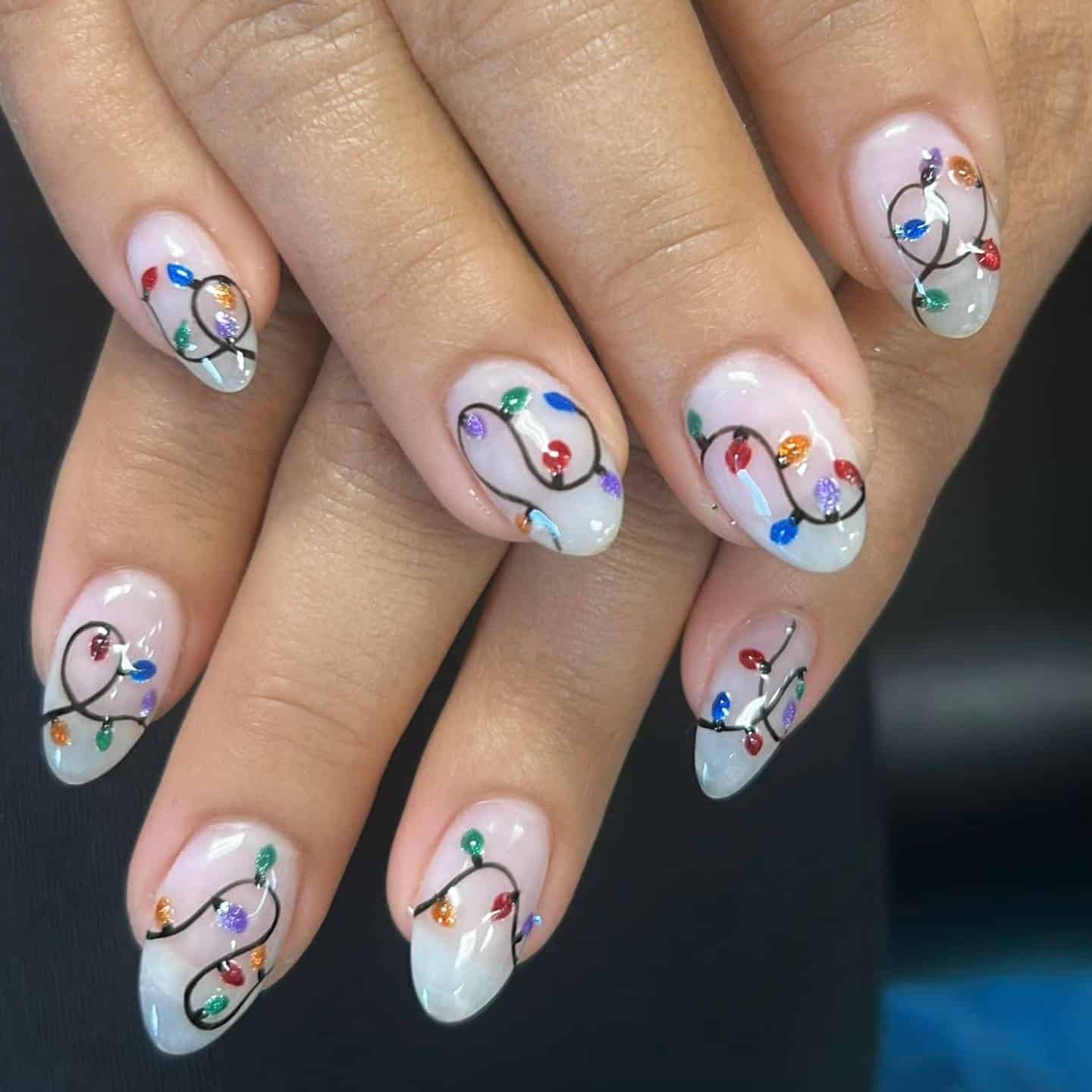 17. Sheer White Nails with Christmas Light String Design - christmas dip nail ideas