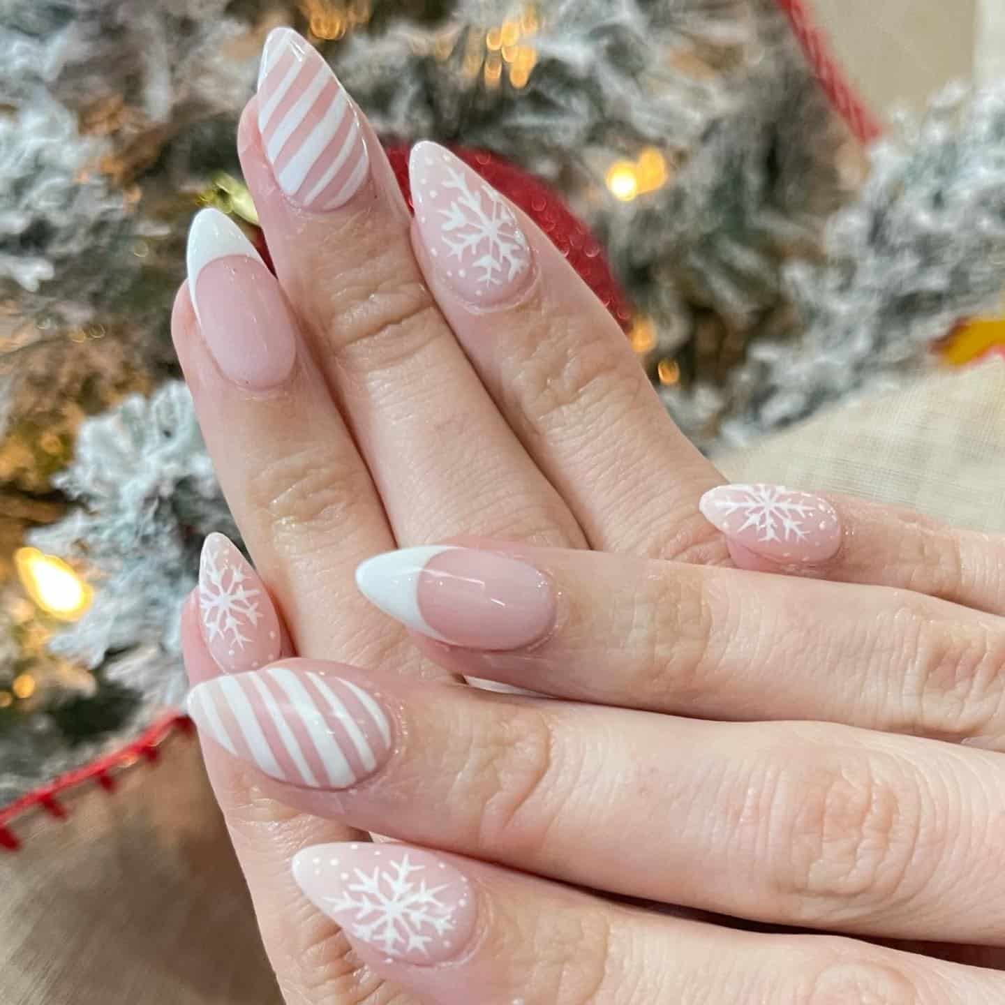 20. Classic Nude and White French Snowflake Almond Nails - christmas dip nail ideas