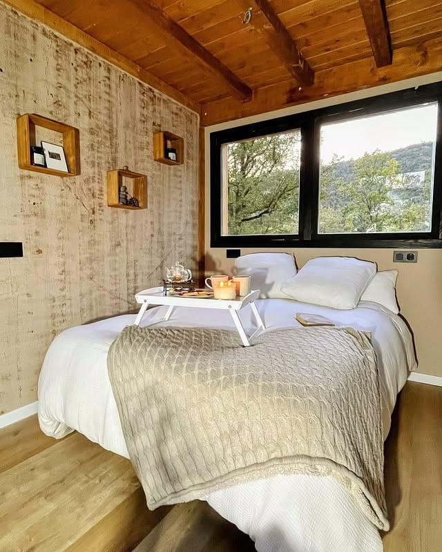 2. Rustic Wood Cabin Bedroom with Neutral Layers - tiny bedroom ideas