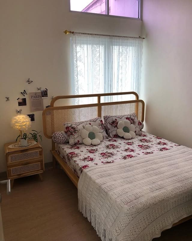 4. Cozy Cane Bed with Floral Accent Styling - tiny bedroom ideas