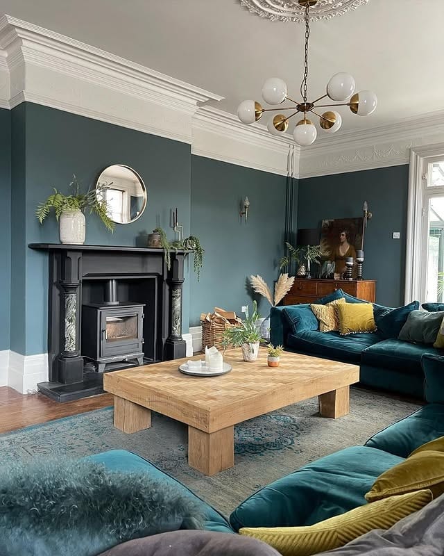 1. Deep Teal Living Room with Classic Fireplace Elegance - blue living room ideas