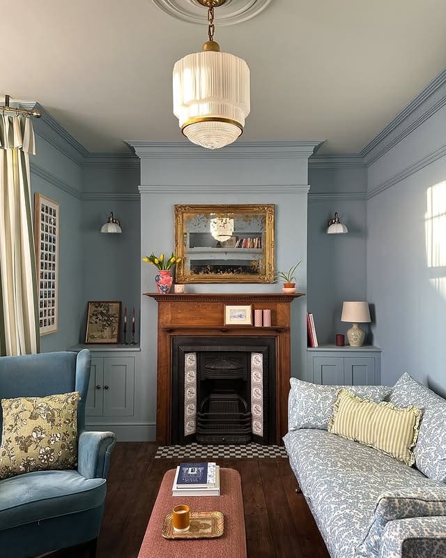 6. Soft Blue Living Room with Traditional Fireplace Charm - blue living room ideas