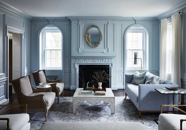 10. Blue Paneled Living Room with Curved Sofa Design - blue living room ideas