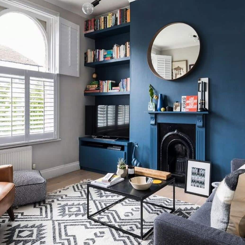 21. Classic Blue Living Room with Built-In Shelving and Fireplace - blue living room ideas