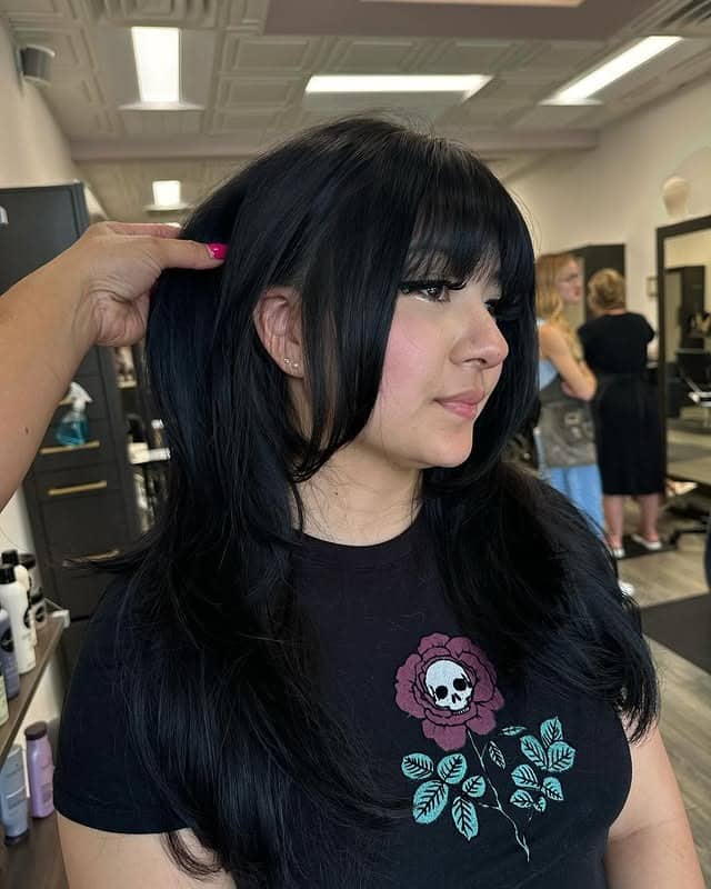 5. Jet Black Layered Style with Textured Wispy Bangs - Wispy Bangs Hairstyles