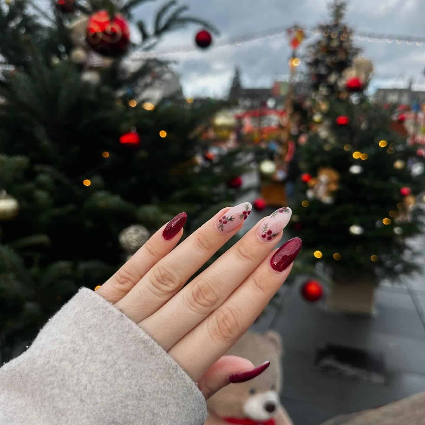 4. Burgundy Glitter Almond Nails with Floral Winter Details - christmas nail ideas