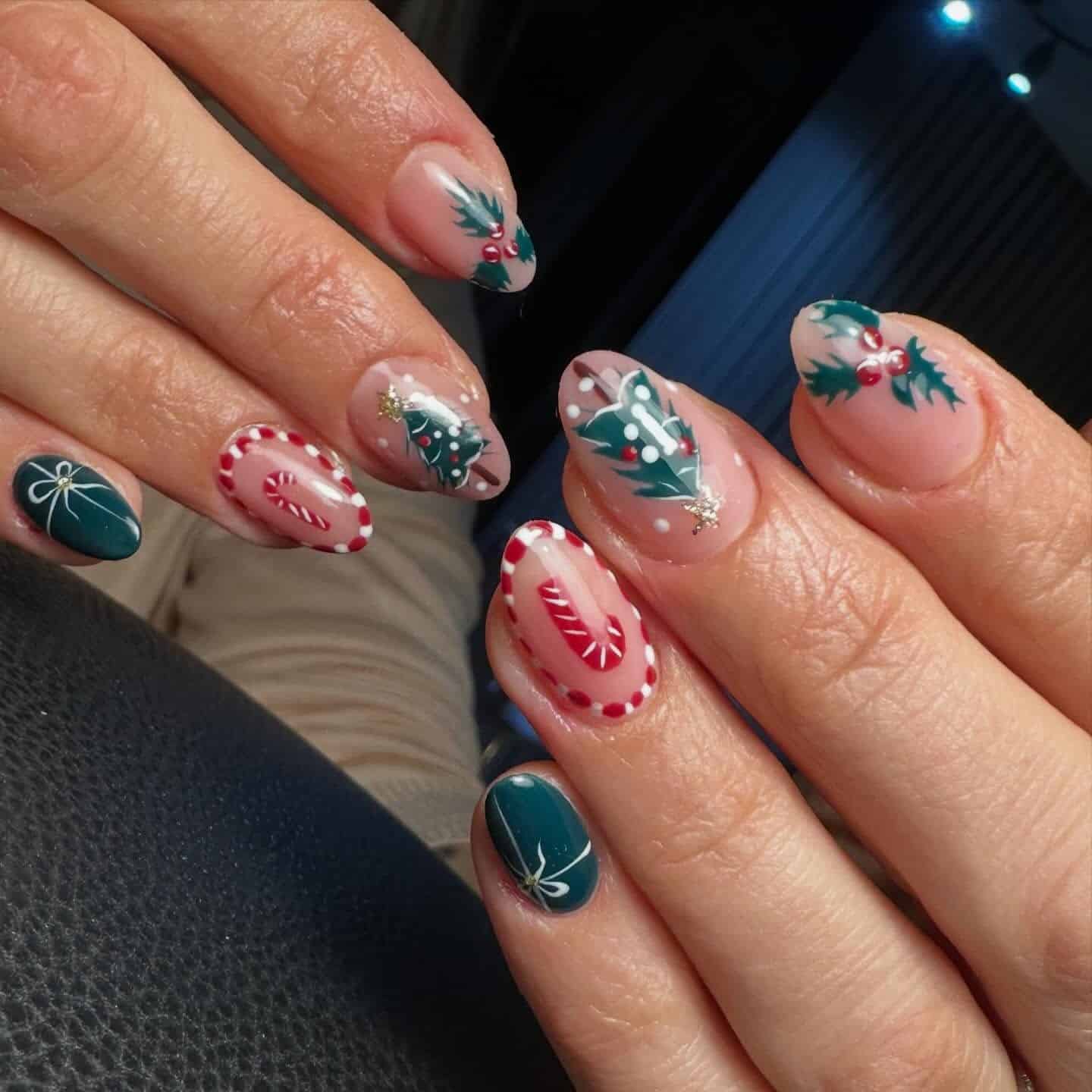 12. Short Almond Nude Nails with Christmas Tree and Candy Cane Art - christmas nail ideas