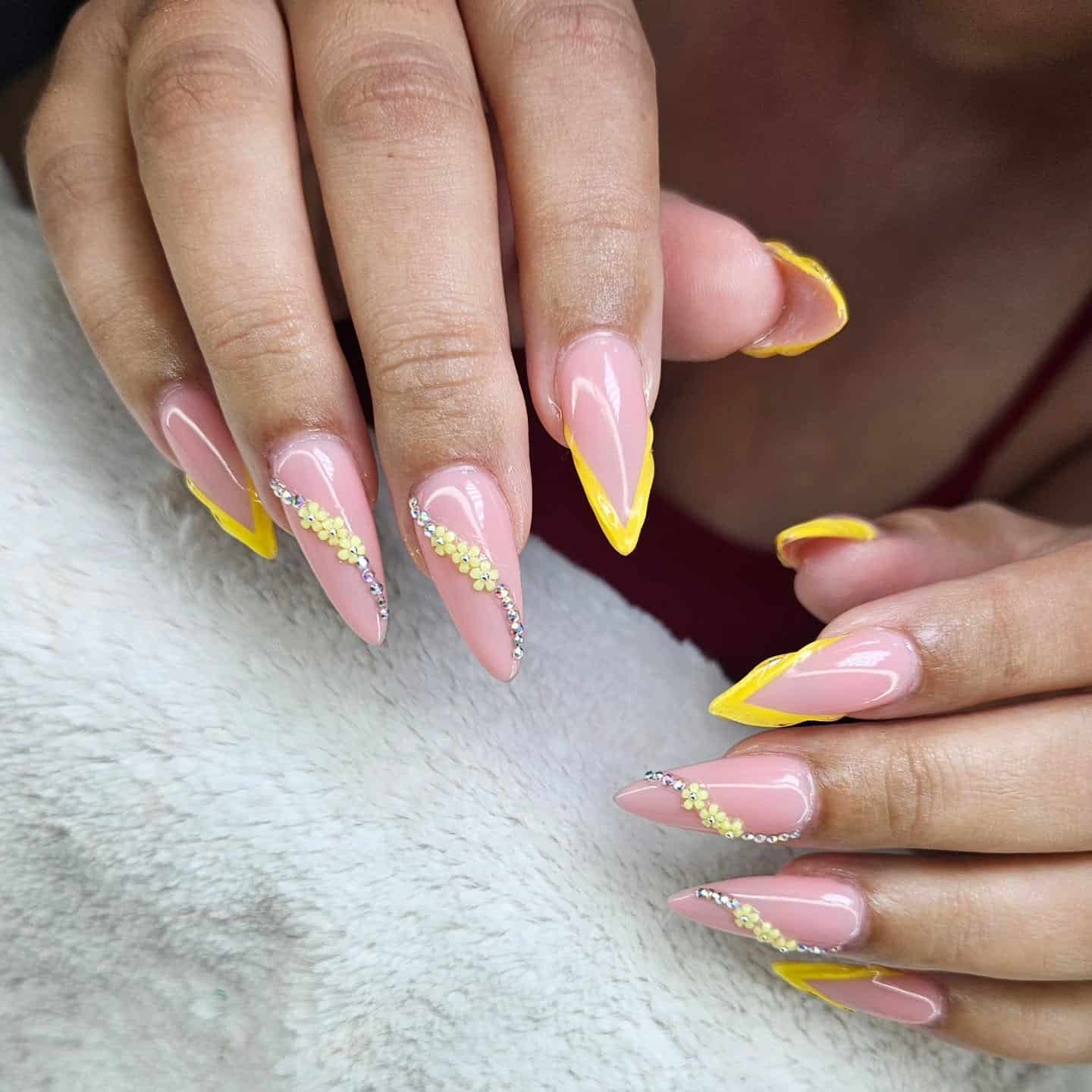2. Nude Pink Stiletto Nails with Yellow French Tips and Rhinestone Curves - nail ideas with gems