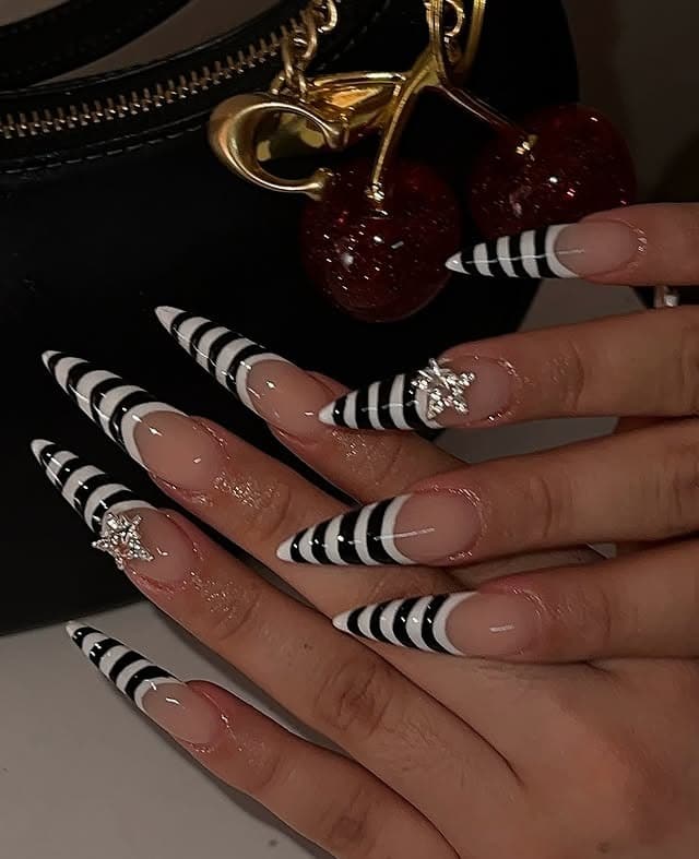 12. Black and Nude Stiletto Nails with Striped French Tips and Crystal Clusters - nail ideas with gems