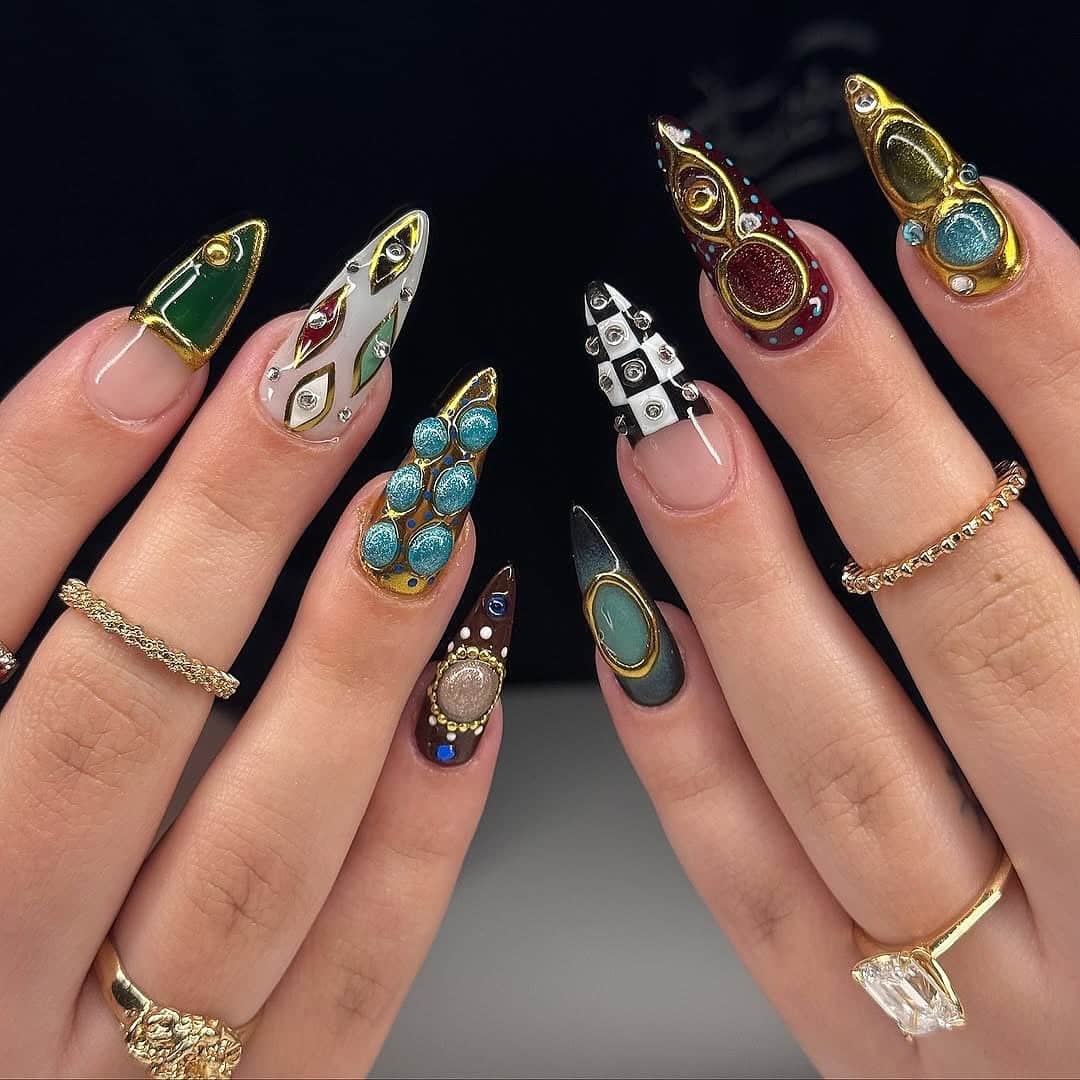 14. Mixed Design Stiletto Nails with Jewel-Toned Gems and Gold Frames - nail ideas with gems