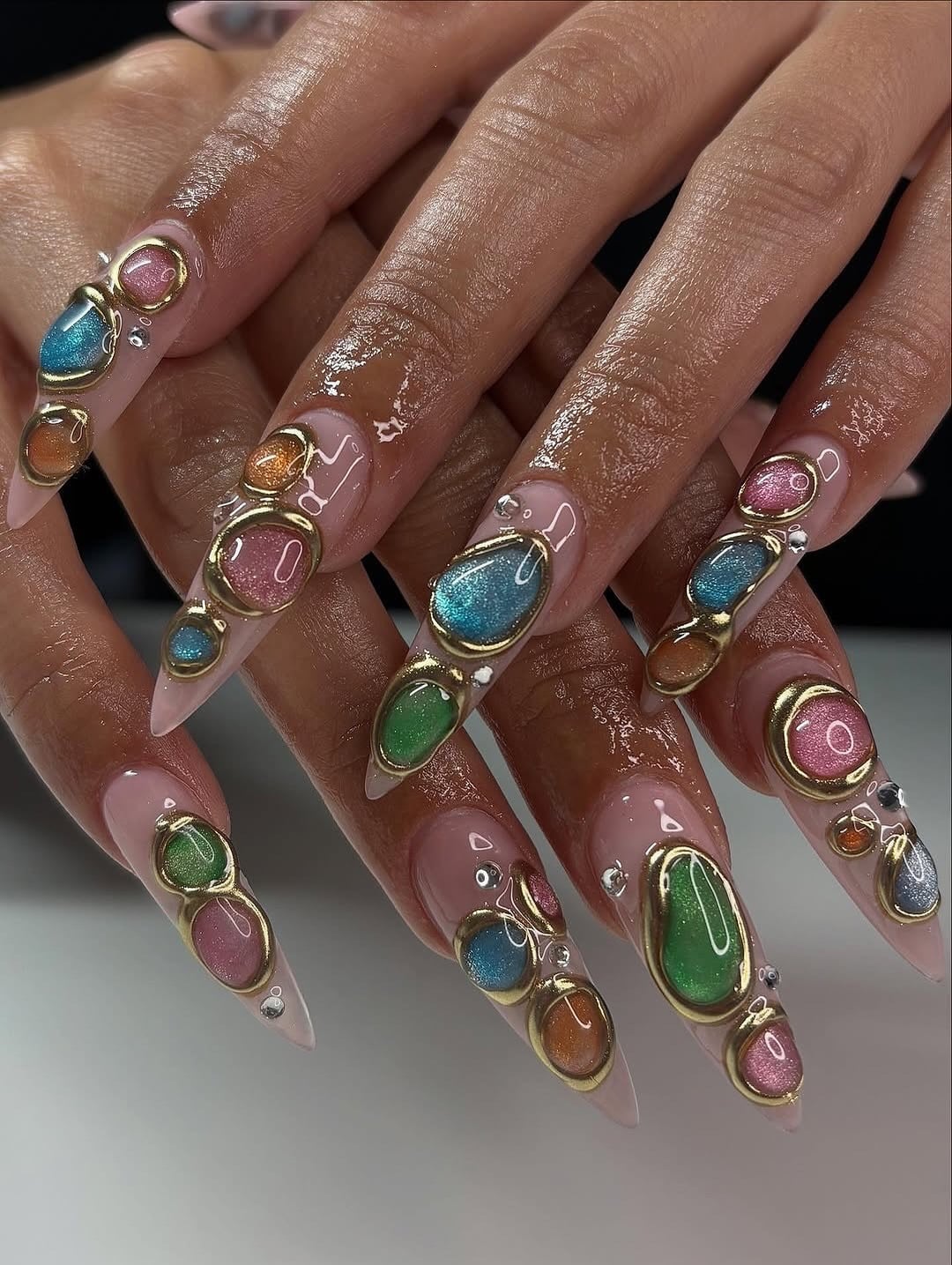 18. Nude Stiletto Nails with Multicolor Encapsulated Gems and Gold Outlines - nail ideas with gems