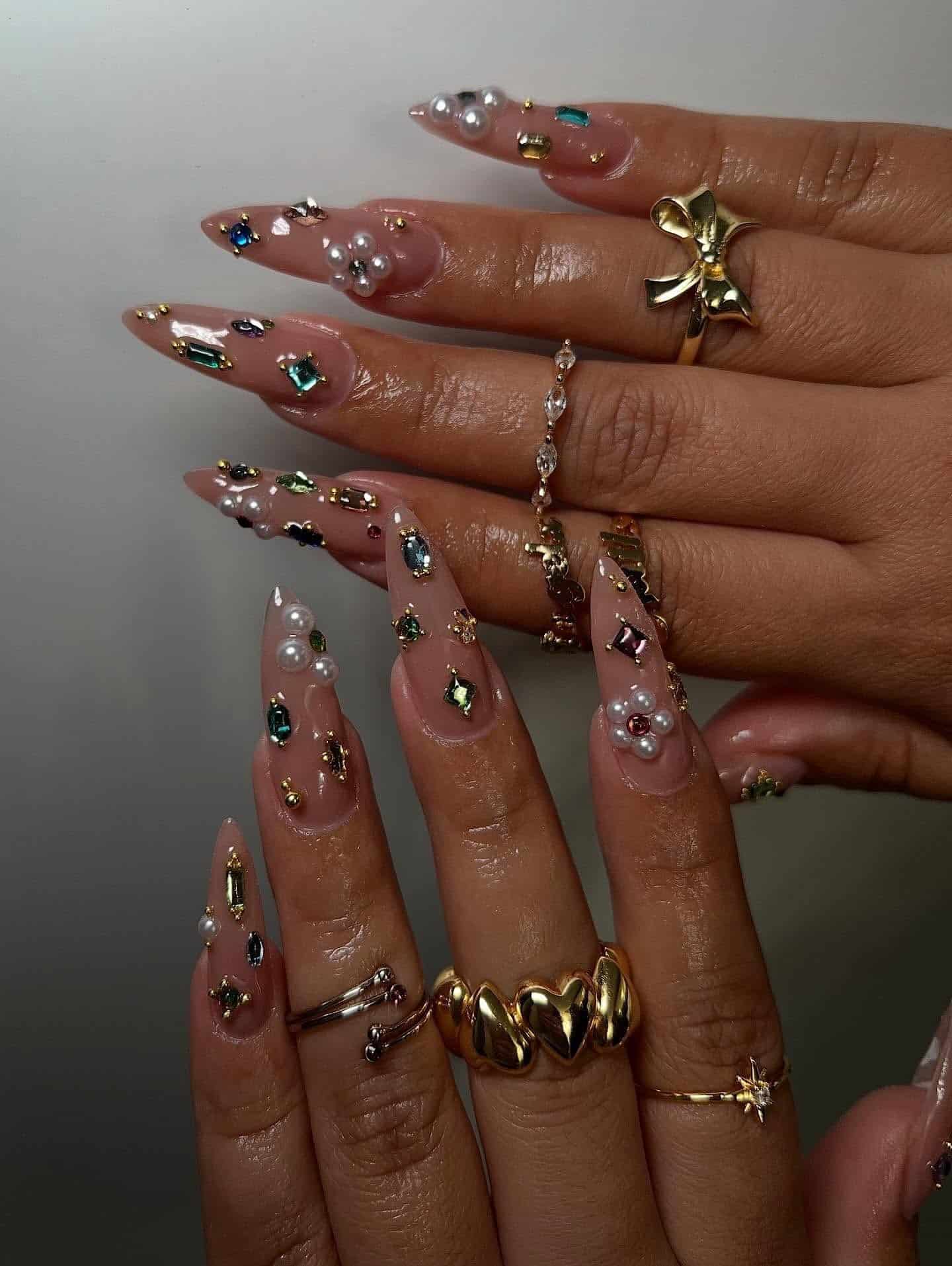19. Nude Almond Nails with Pearl Clusters and Multicolor Crystal Accents - nail ideas with gems