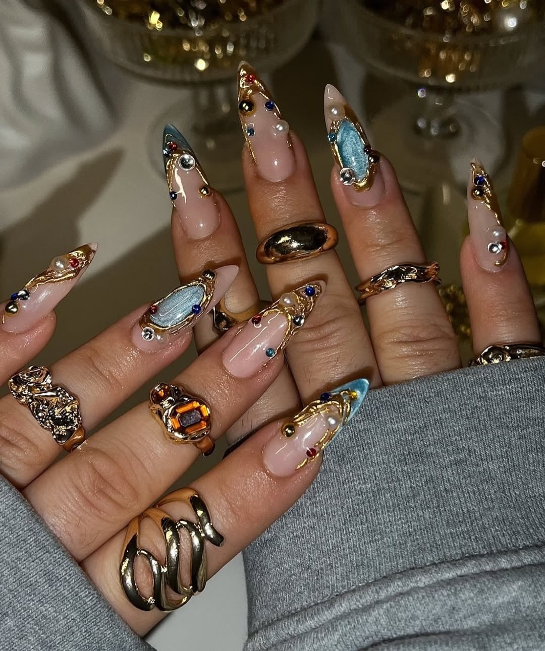 20. Soft Pink Stiletto Nails with Blue Chrome Accents and Gold Gem Detailing - nail ideas with gems