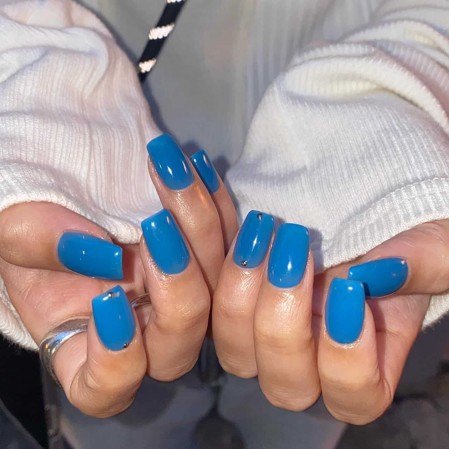 15. Bright Blue Medium Square Nails with Stud Accents - one color nail ideas