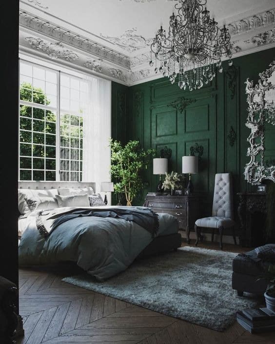 3. Classic Emerald Paneling with Chandelier Elegance - emerald green bedroom ideas