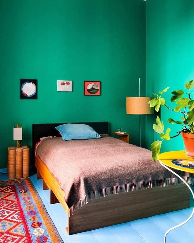 9. Bright Emerald Wall with Eclectic Touches - emerald green bedroom ideas