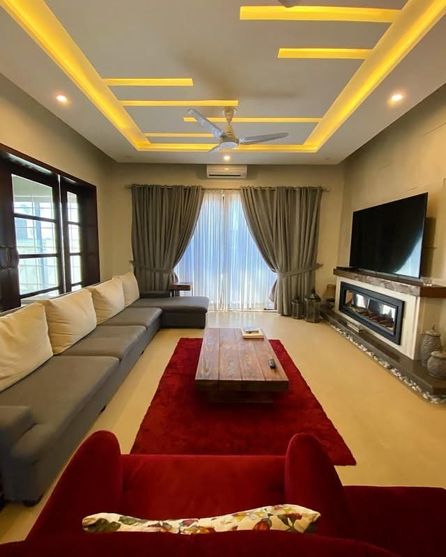 3. Warm Contemporary Living Room with Subtle Red Rug - gray and red living room ideas