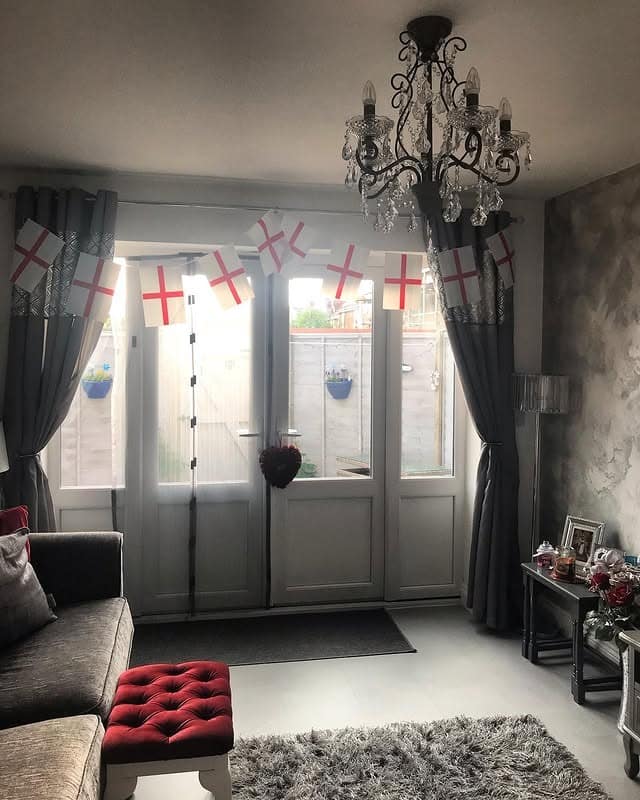 4. Classic Gray Lounge with Deep Red Footstool Accent - gray and red living room ideas