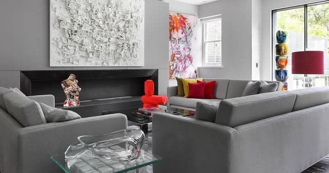 11. Contemporary Gray Living Room with Sculptural Red Accents - gray and red living room ideas