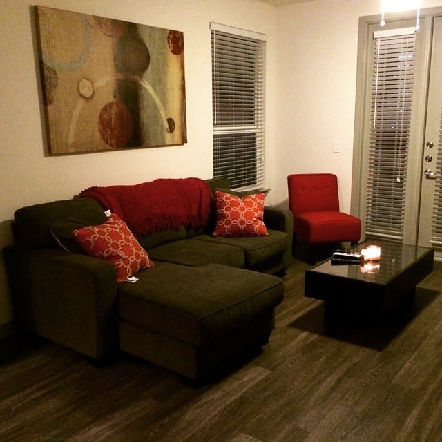 21. Cozy Gray Sectional with Warm Red Accents - gray and red living room ideas