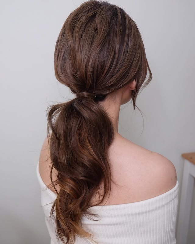 12. Chestnut Brown Low Layered Ponytail with Soft Volume - Layered Ponytail Hairstyles