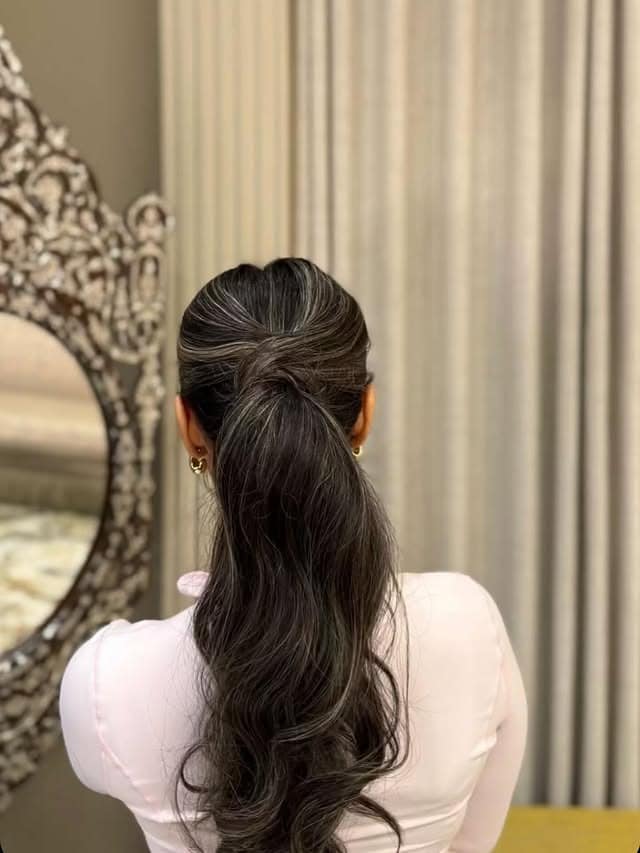 16. Classic Black Low Layered Ponytail with Soft Waves - Layered Ponytail Hairstyles