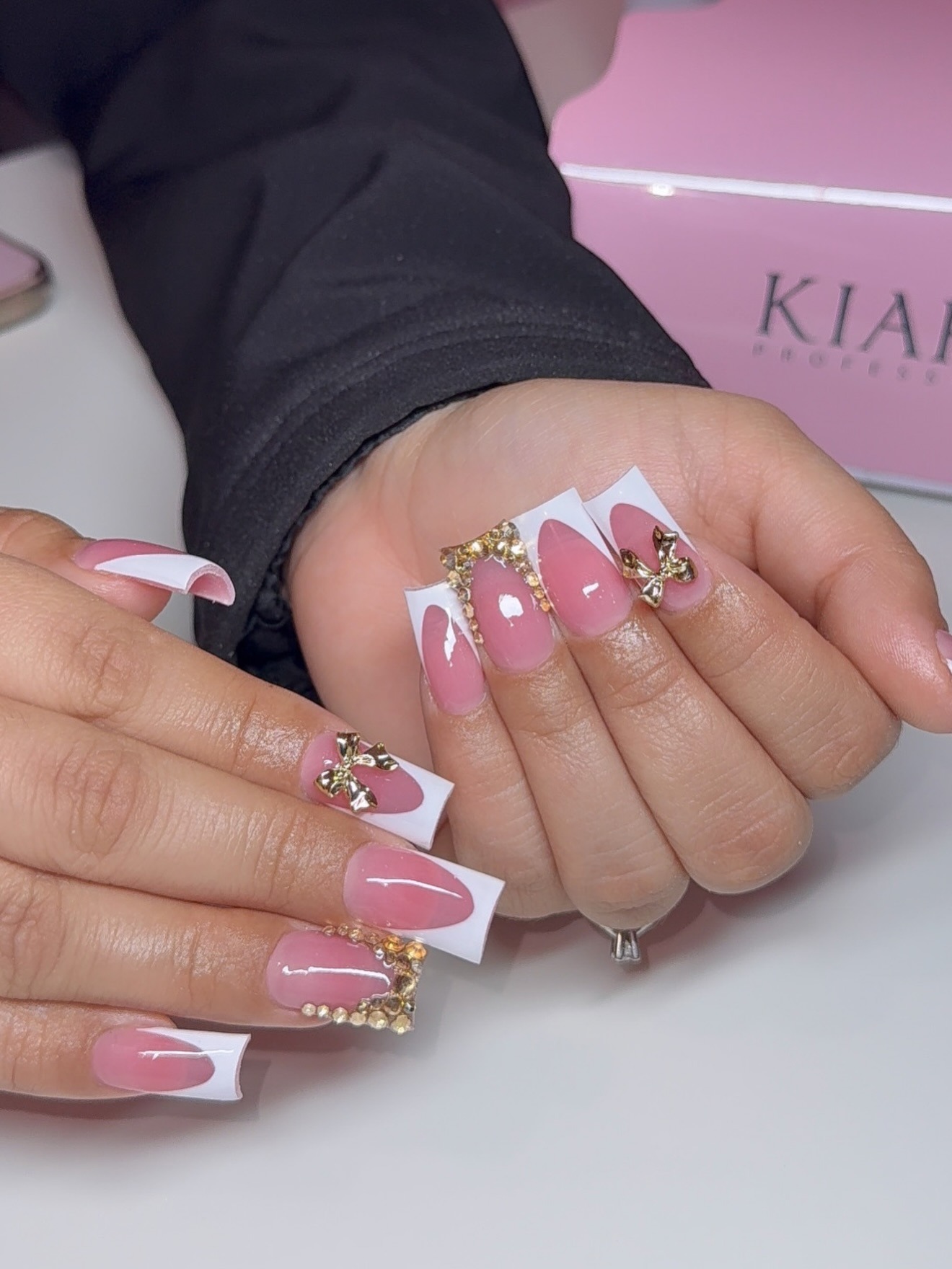 18. Pink Acrylic French Tips with Gold Bow Charms - cute nail ideas
