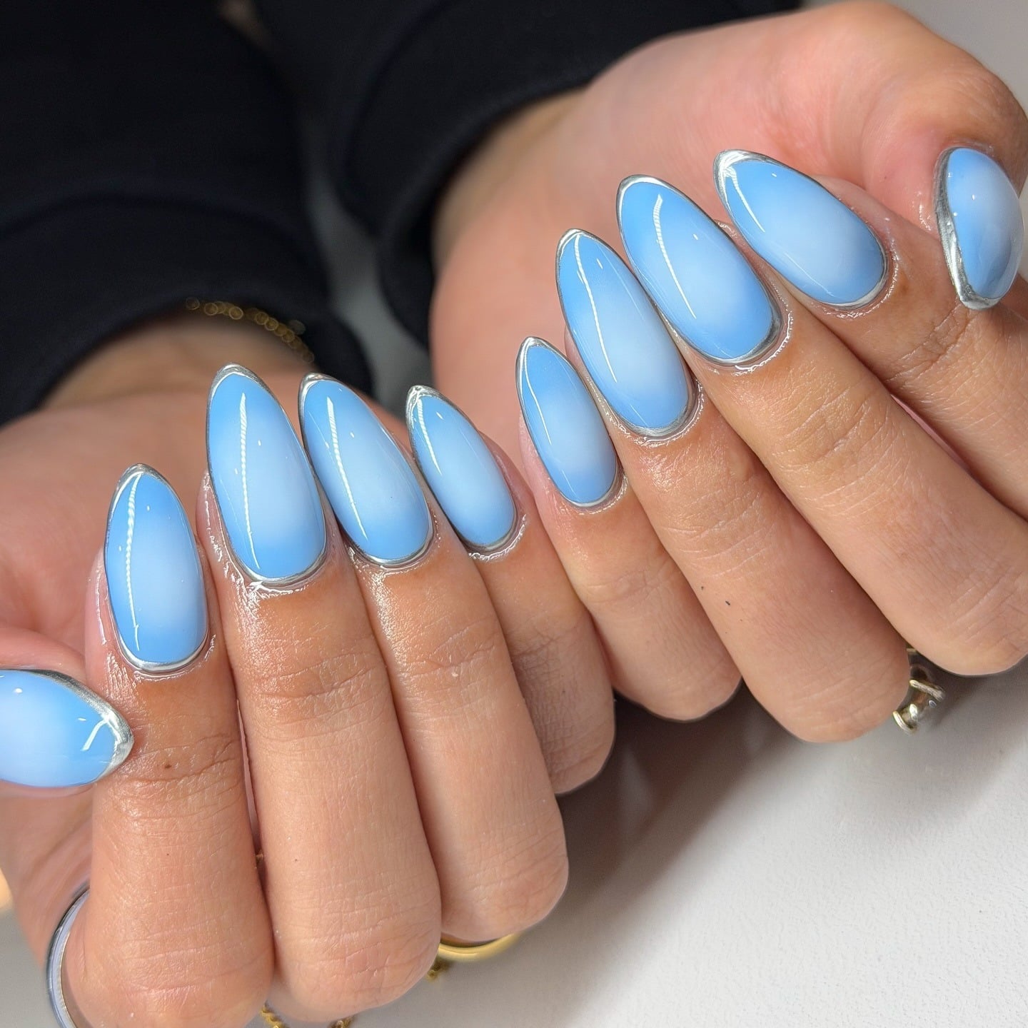 4. Glossy Blue Chrome Outline Almond Nails - blue spring nail ideas