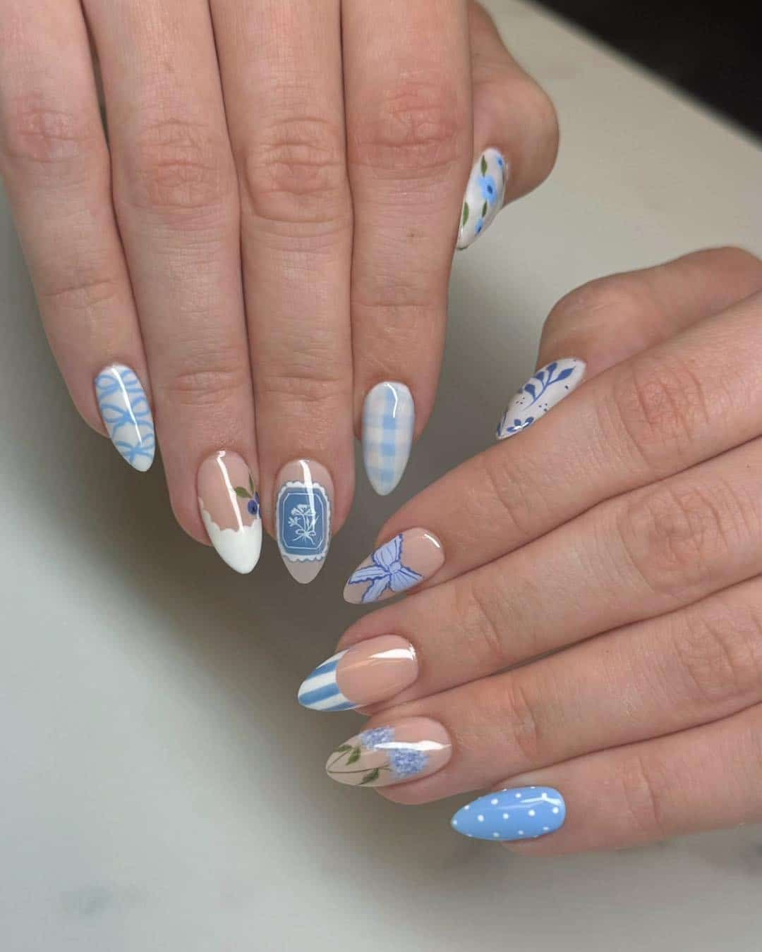 17. Blue Mixed Pattern Almond Nails - blue spring nail ideas