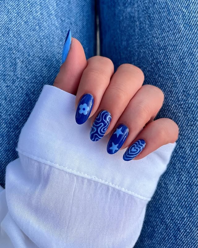 21. Royal Blue Graphic Almond Nails - blue spring nail ideas