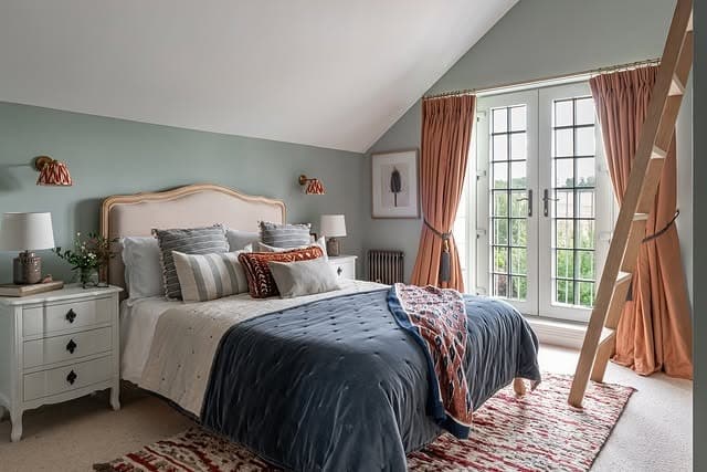 18. Light Blue Bedroom with Warm Accent Tones and Layered Textiles - light blue bedroom ideas
