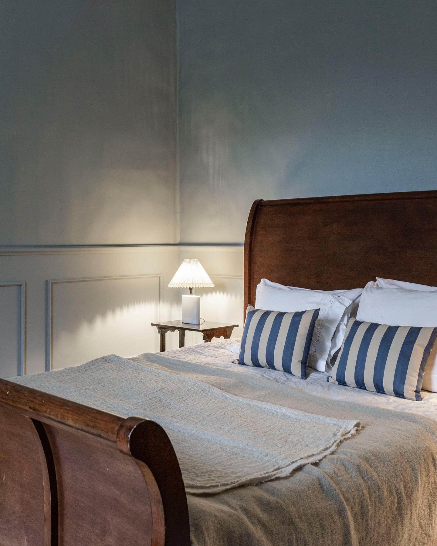 19. Traditional Light Blue Bedroom with Classic Paneling - light blue bedroom ideas