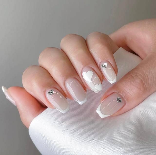16. Milky Nude French with White Heart Accents - basic nail ideas