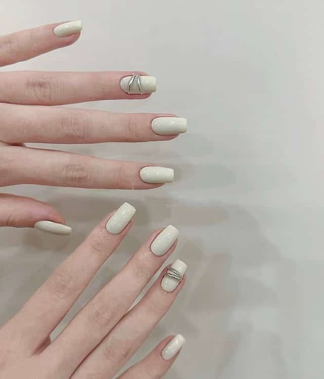 17. Solid Ivory Square Nails with Minimal Metallic Detail - basic nail ideas