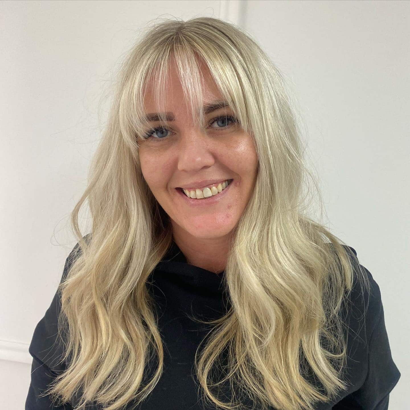 22. Creamy Blonde Layers with Soft Feather Fringe - Feather Fringe Hair