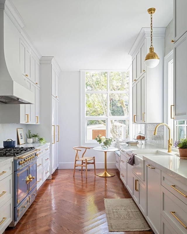 5. Bright White Galley Kitchen with Warm Wood Flooring - galley kitchen ideas